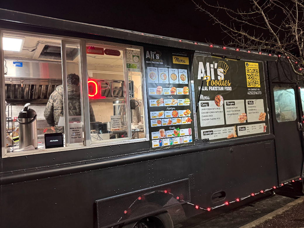 The truck after dark, fairy lights along the awning and the menu boards lit